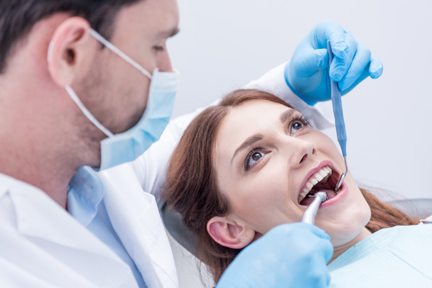 dentist curing patients teeth